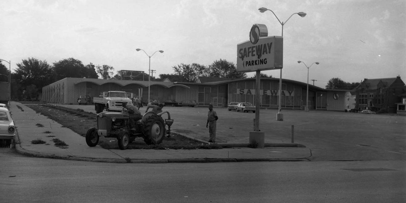 Vintage image of a person and tractor outside of a Safeway grocery store Vintage image of a person and tractor outside of a Safeway grocery store
